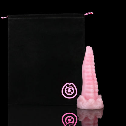 Tendrul the Tentacle dildo, Fairy Floss colorway, shown alongside the included black Lunara's Realm storage pouch