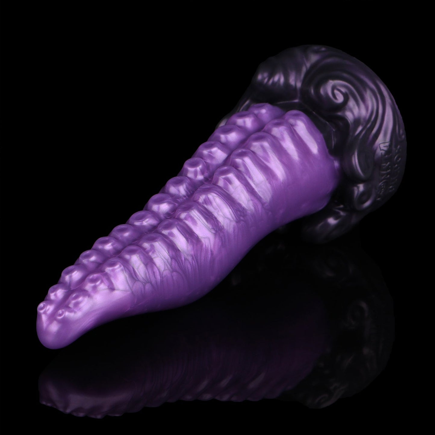 Tendrul the Tentacle dildo, Grape colorway, lying at an angle with the suckers toward the camera and the sculpted base to the right