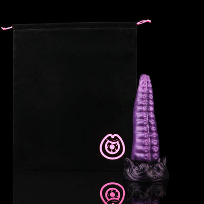 Tendrul the Tentacle dildo, Grape colorway, shown alongside the included black Lunara's Realm storage pouch