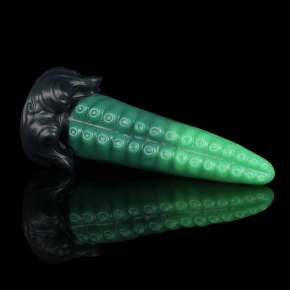 Tendrul the Tentacle dildo, Ogre colorway, lying on its side in full profile showing the green tentacle and midnight olive whirlpool base