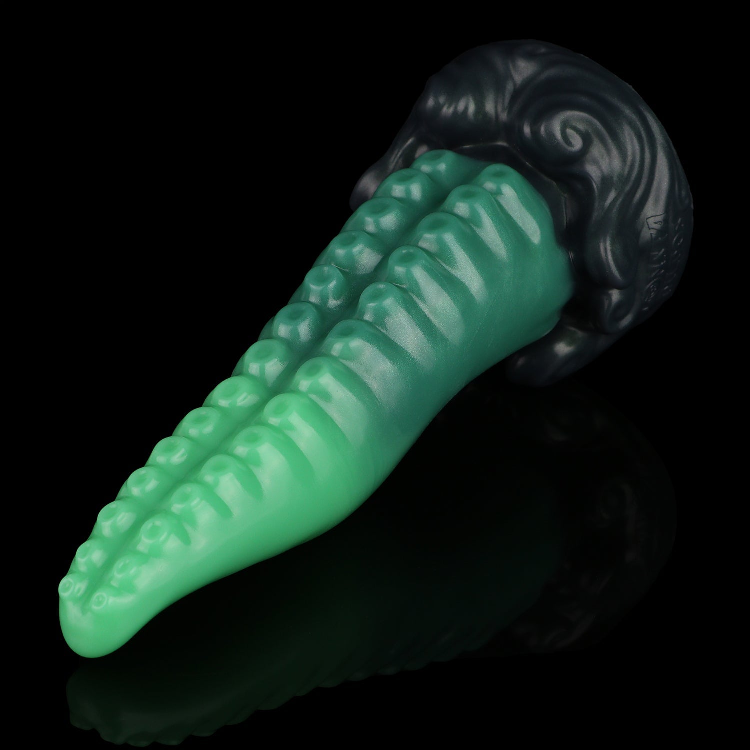Tendrul the Tentacle dildo, Ogre colorway, lying at an angle with the suckers facing up and the sculpted base to the right