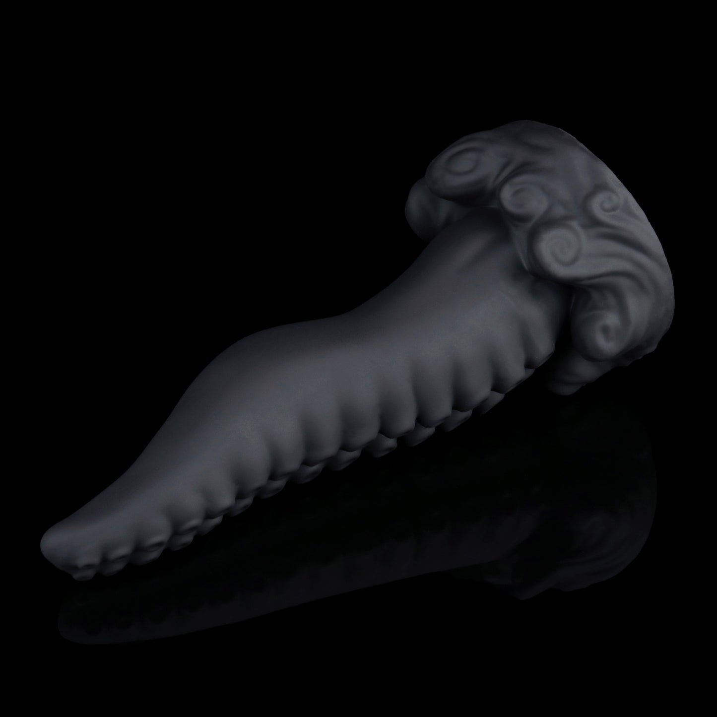 Tendrul the Tentacle dildo, Shadow colorway, lying at an angle showing the rows of suckers along the meandering shaft