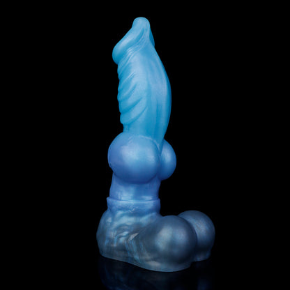 Vulpes the Nightfox dildo, Arctic colorway, standing upright at an angle showing the luminous icy blue shaft above the slate-blue base